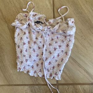 White cropped tank top with floral design.